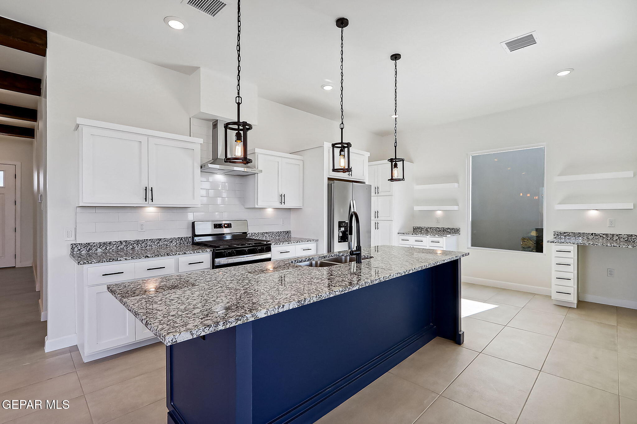 5997 Ruidoso Downs Street El Paso, TX 79932 - Photo 2 of 42 a kitchen with stainless steel appliances granite countertop a sink a stove and a wooden floor
