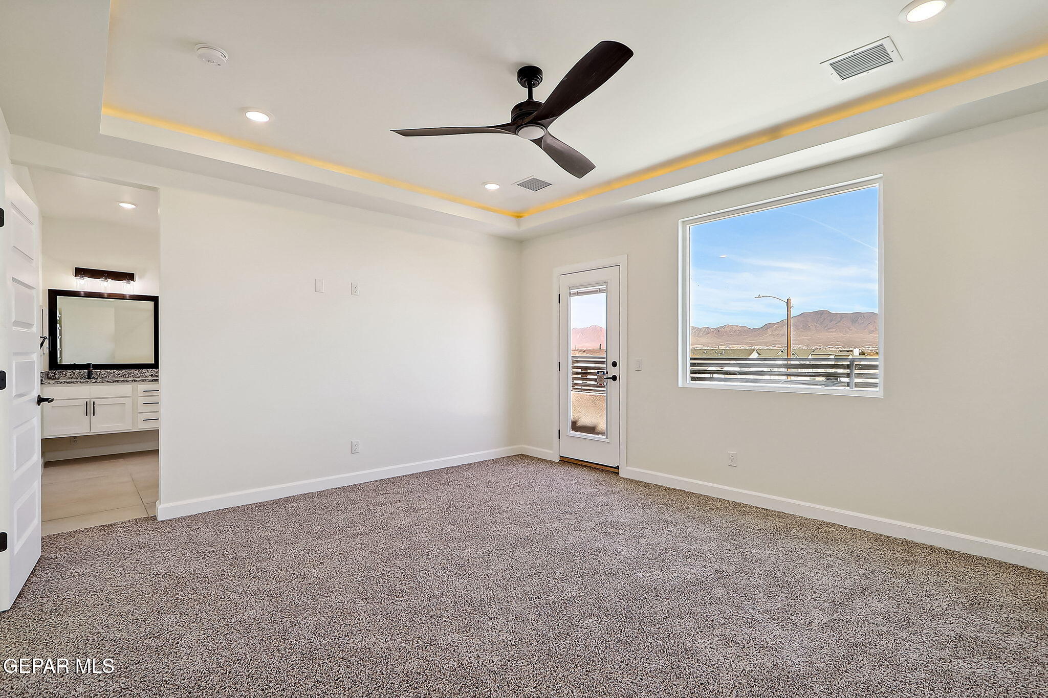 5997 Ruidoso Downs Street El Paso, TX 79932 - Photo 22 of 42 an empty room with windows and ceiling fan