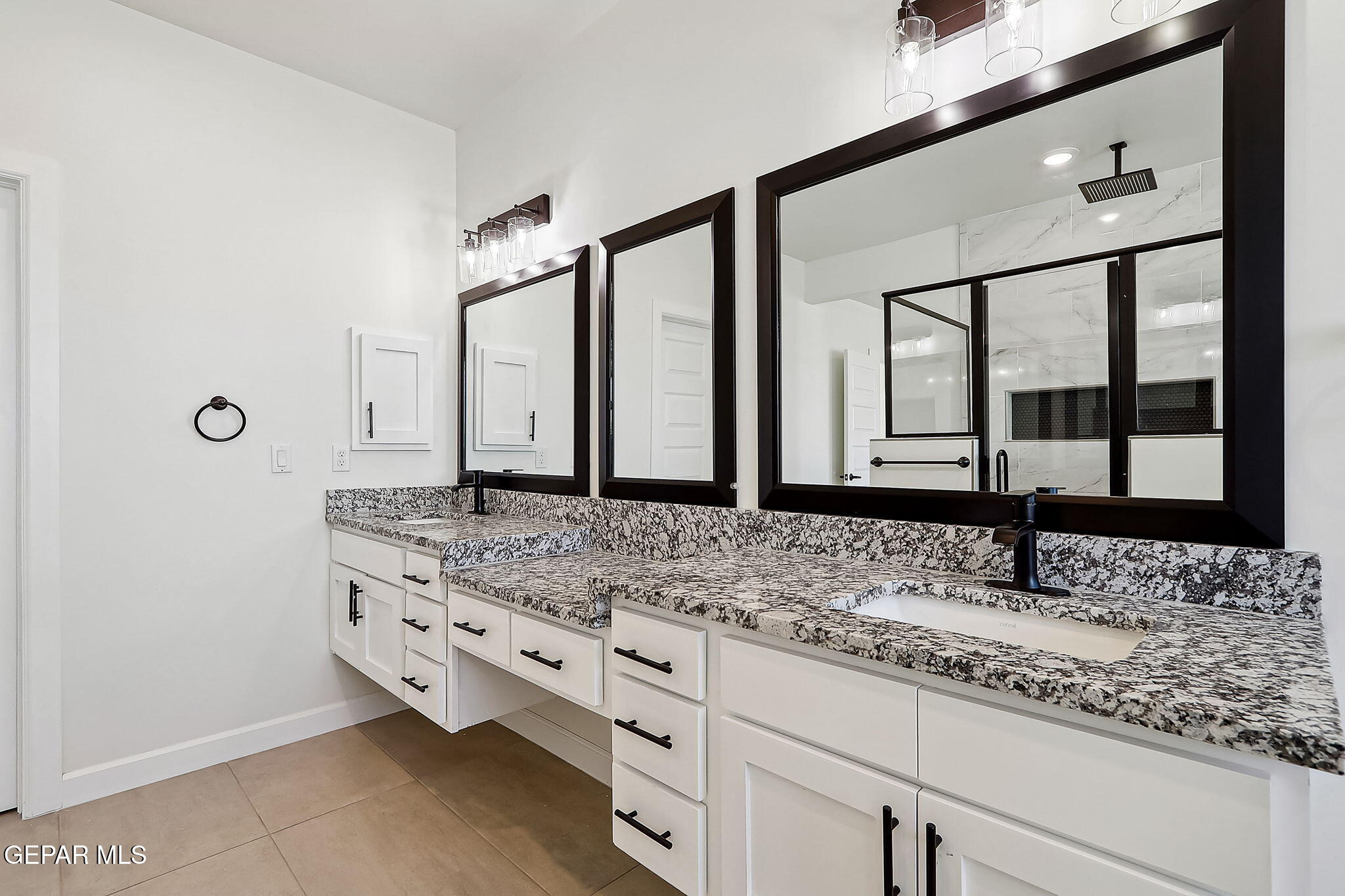 5997 Ruidoso Downs Street El Paso, TX 79932 - Photo 26 of 42 a bathroom with a granite countertop sink and large window