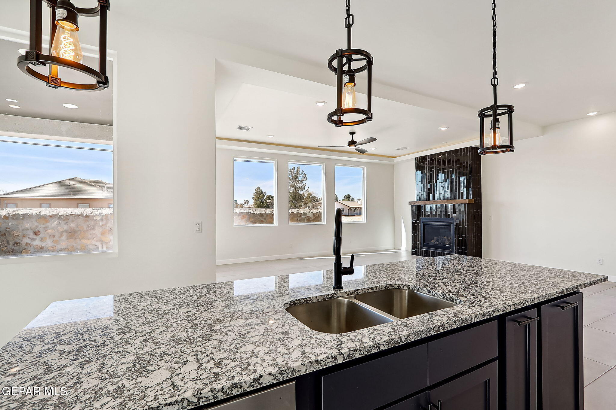 5997 Ruidoso Downs Street El Paso, TX 79932 - Photo 4 of 42 a kitchen with a sink a counter space and wooden floor
