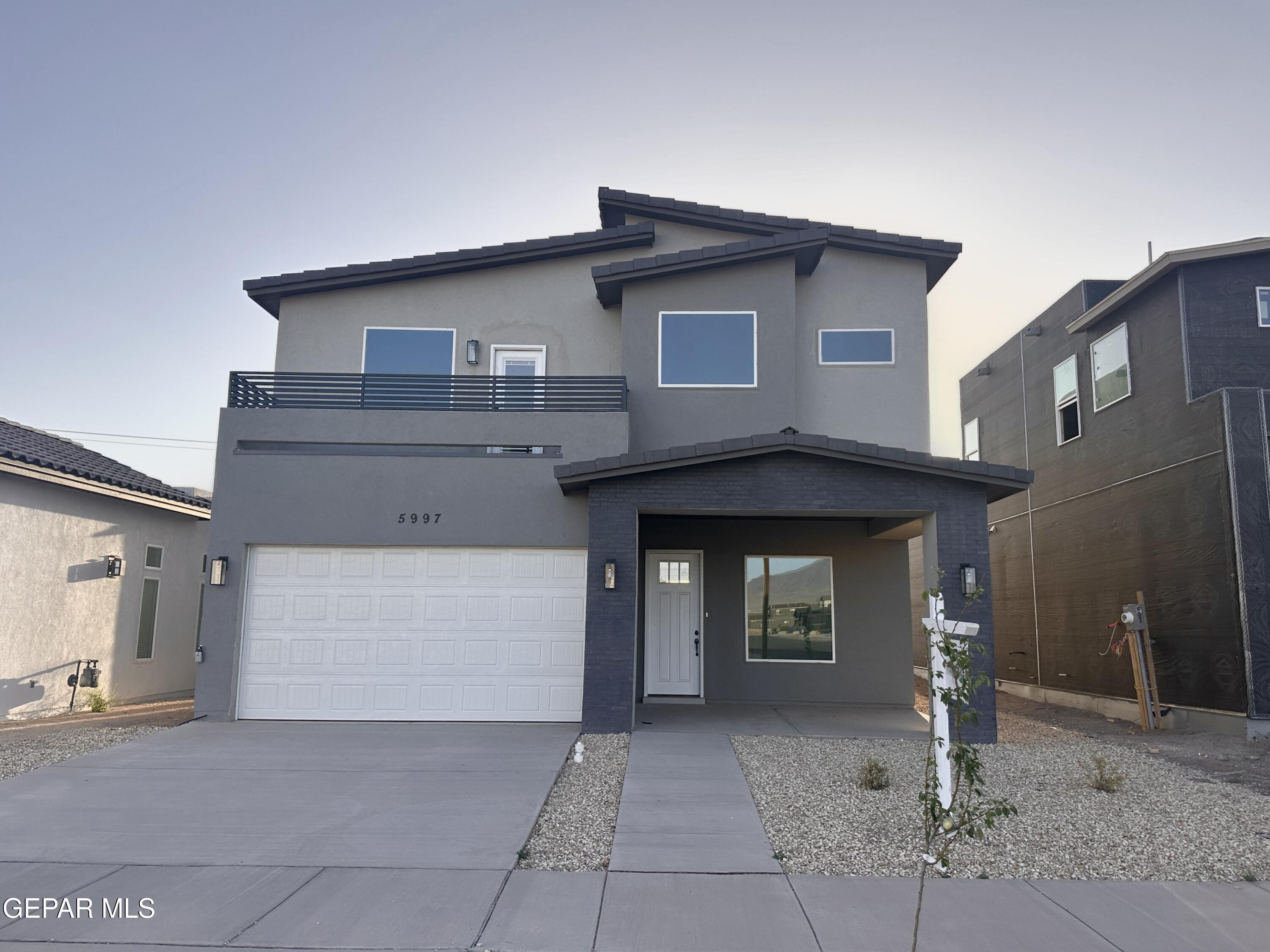 5997 Ruidoso Downs Street El Paso, TX 79932 - Photo 42 of 42 a front view of a house with garage