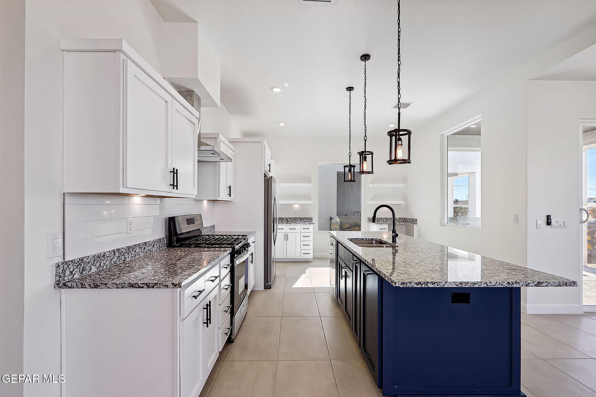 5997 Ruidoso Downs Street El Paso, TX 79932 - Photo 5 of 42 a kitchen with stainless steel appliances granite countertop a sink stove and refrigerator