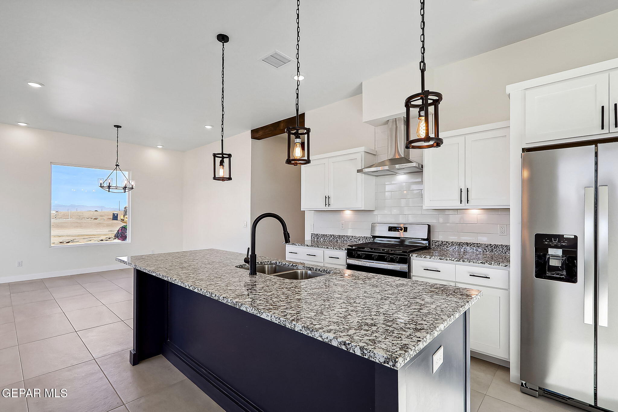 5997 Ruidoso Downs Street El Paso, TX 79932 - Photo 6 of 42 a kitchen with stainless steel appliances granite countertop a sink refrigerator and cabinets