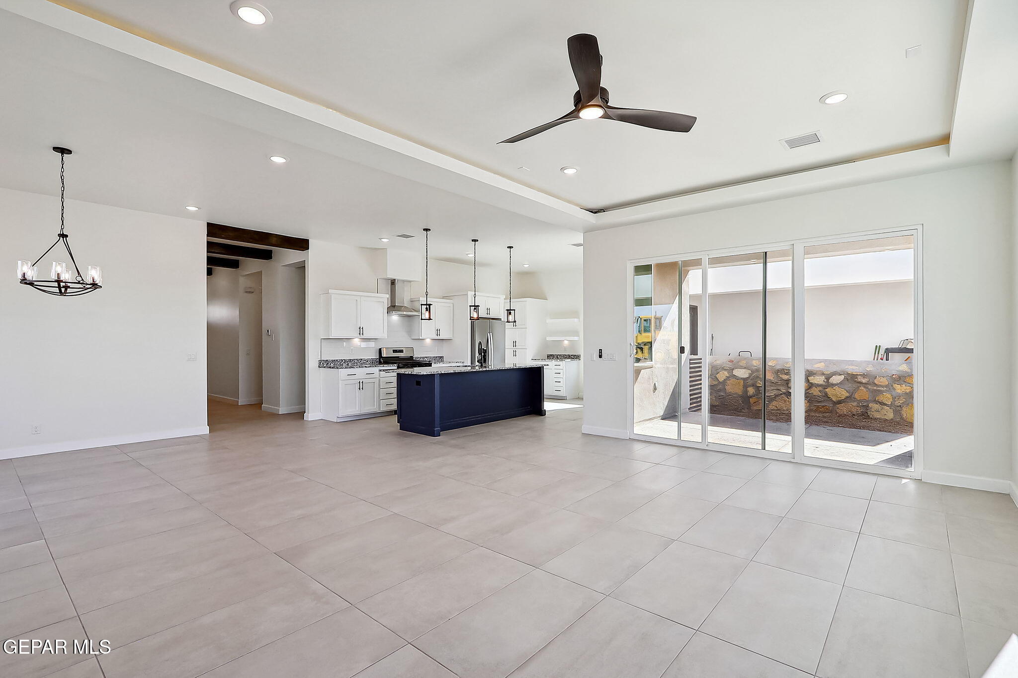 5997 Ruidoso Downs Street El Paso, TX 79932 - Photo 10 of 42 a large room with stainless steel appliances kitchen island granite countertop a refrigerator and a sink