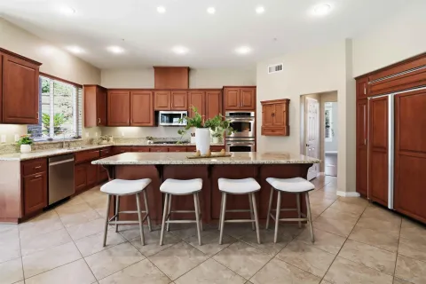 a kitchen with stainless steel appliances granite countertop a stove microwave and cabinets
