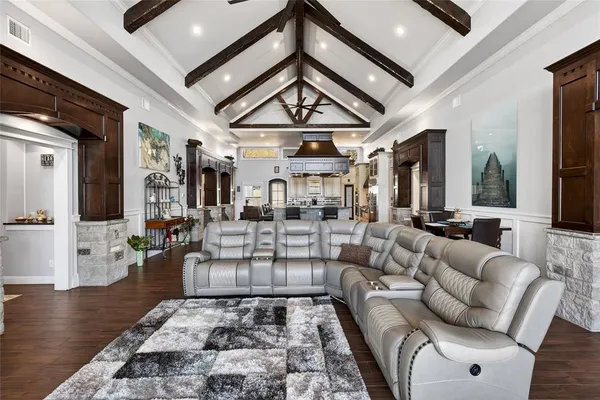 a living room with furniture a fireplace and a chandelier
