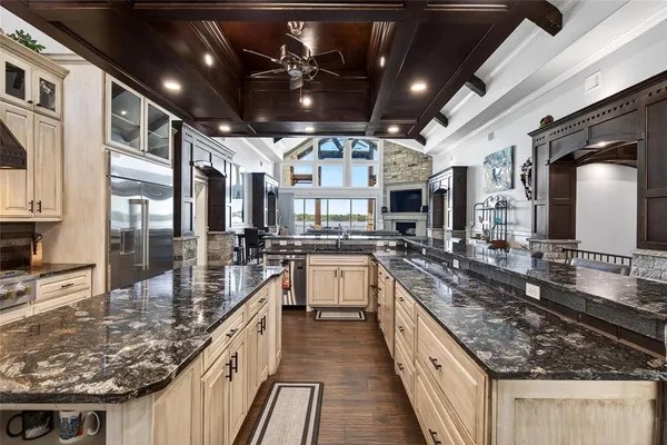 a kitchen with stainless steel appliances granite countertop a sink a stove and cabinets