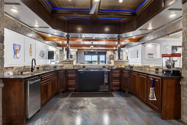 a view of a room with lots of furniture and a large window