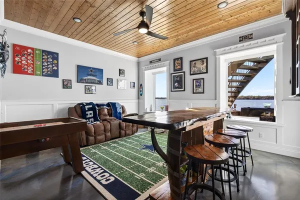 a dining room with furniture and kitchen view