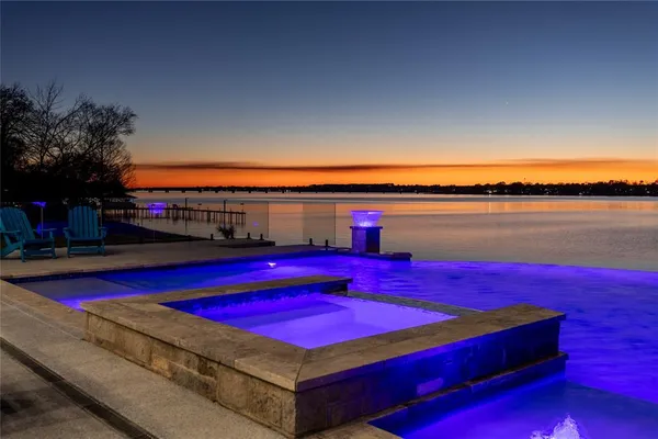 a view of a house with swimming pool and sitting area