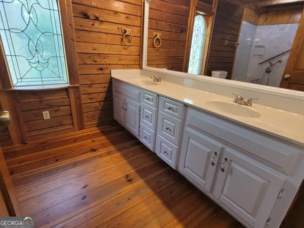 a view of a room with wooden floor