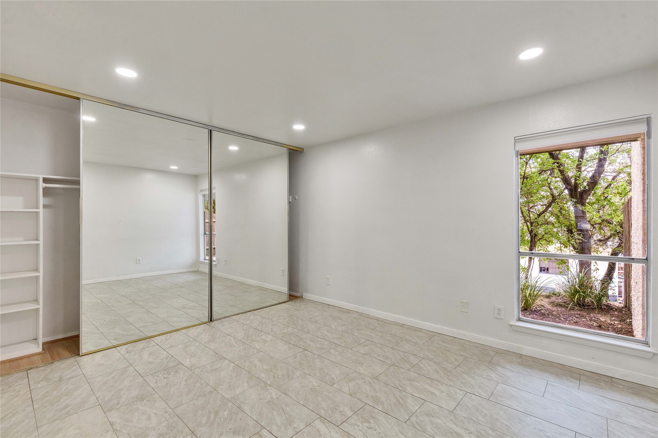 6910 Hart Lane, Unit 403 Austin, TX 78731 - Photo 11 of 20 an empty room with large windows and mountain view
