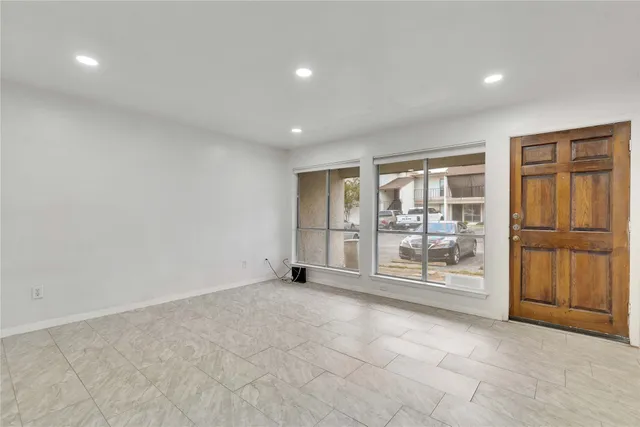 a view of backyard with large trees and wooden fence