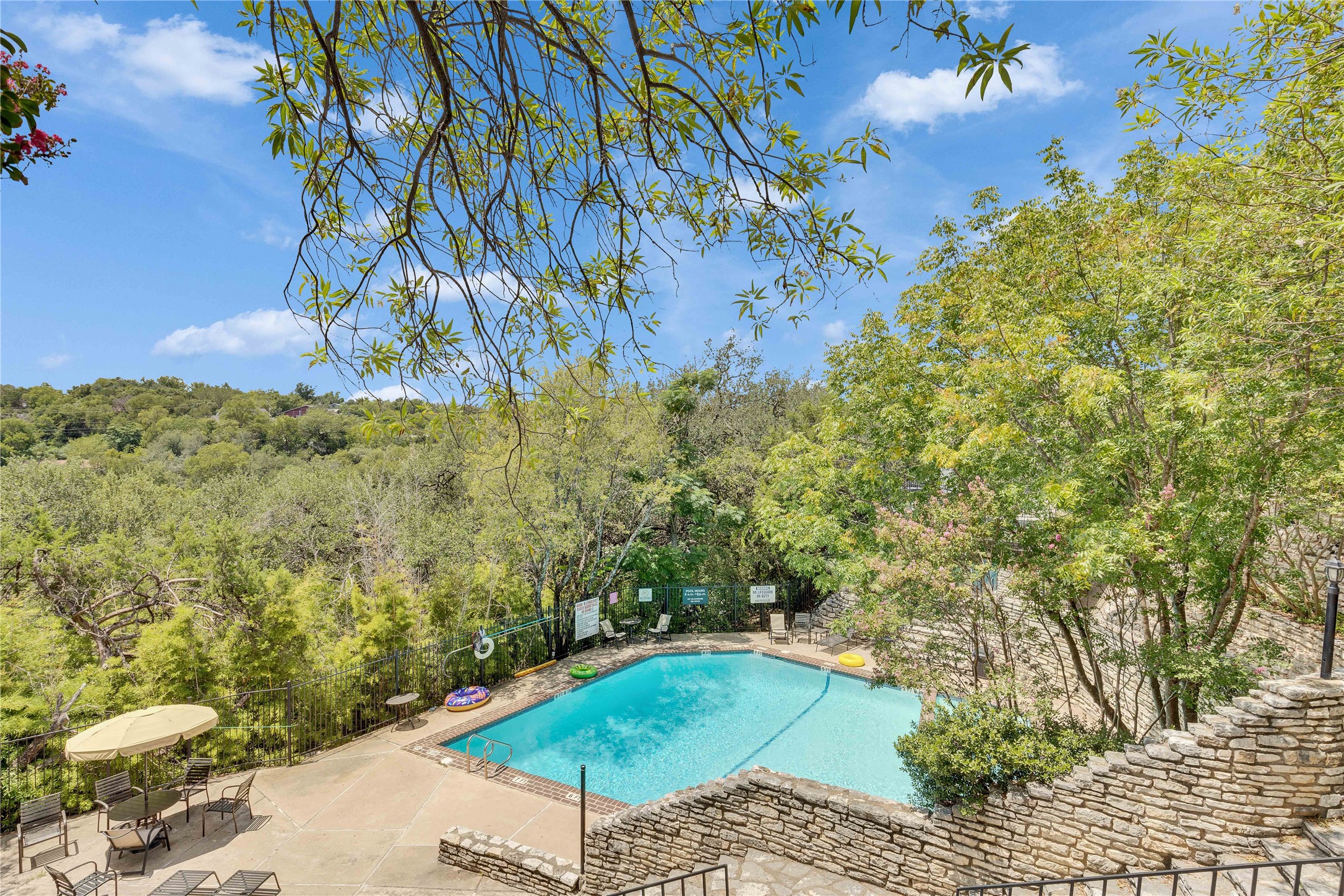 6910 Hart Lane, Unit 403 Austin, TX 78731 - Photo 20 of 20 a view of a yard with plants and large trees