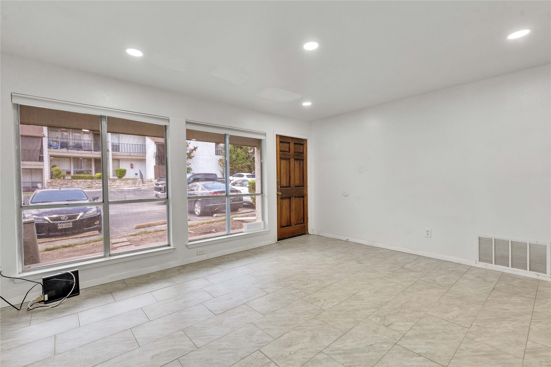 6910 Hart Lane, Unit 403 Austin, TX 78731 - Photo 3 of 20 an empty room with sliding door