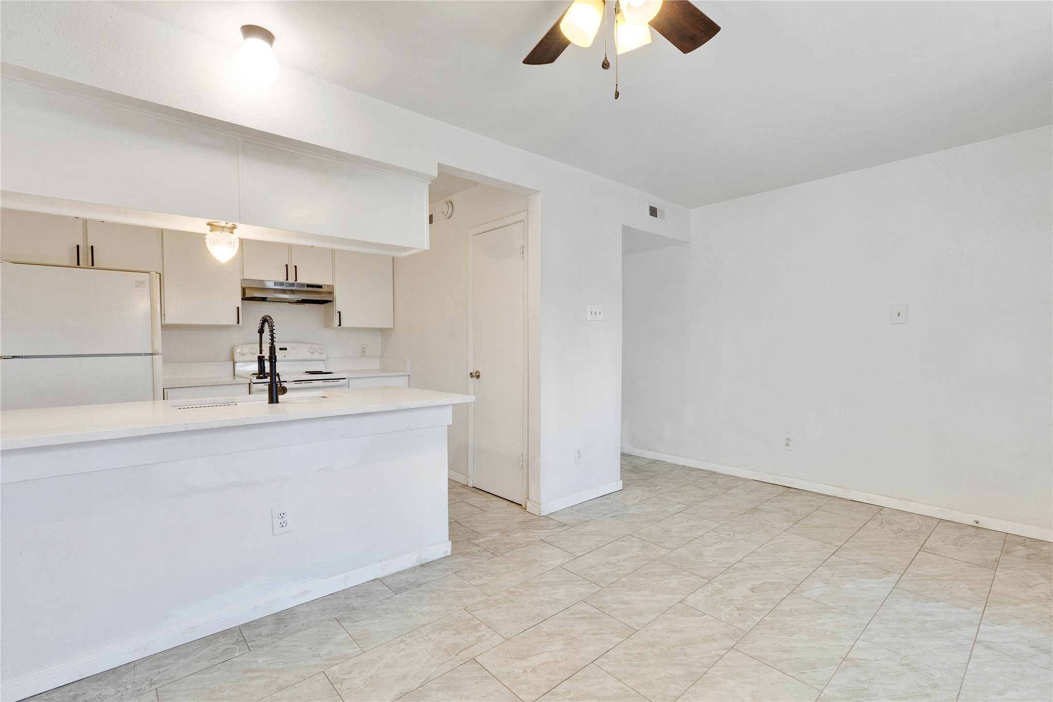 6910 Hart Lane, Unit 403 Austin, TX 78731 - Photo 5 of 20 a view of a kitchen with a sink cabinetry and chandelier