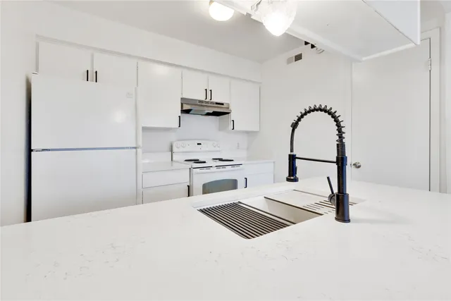 a kitchen with cabinets and white appliances