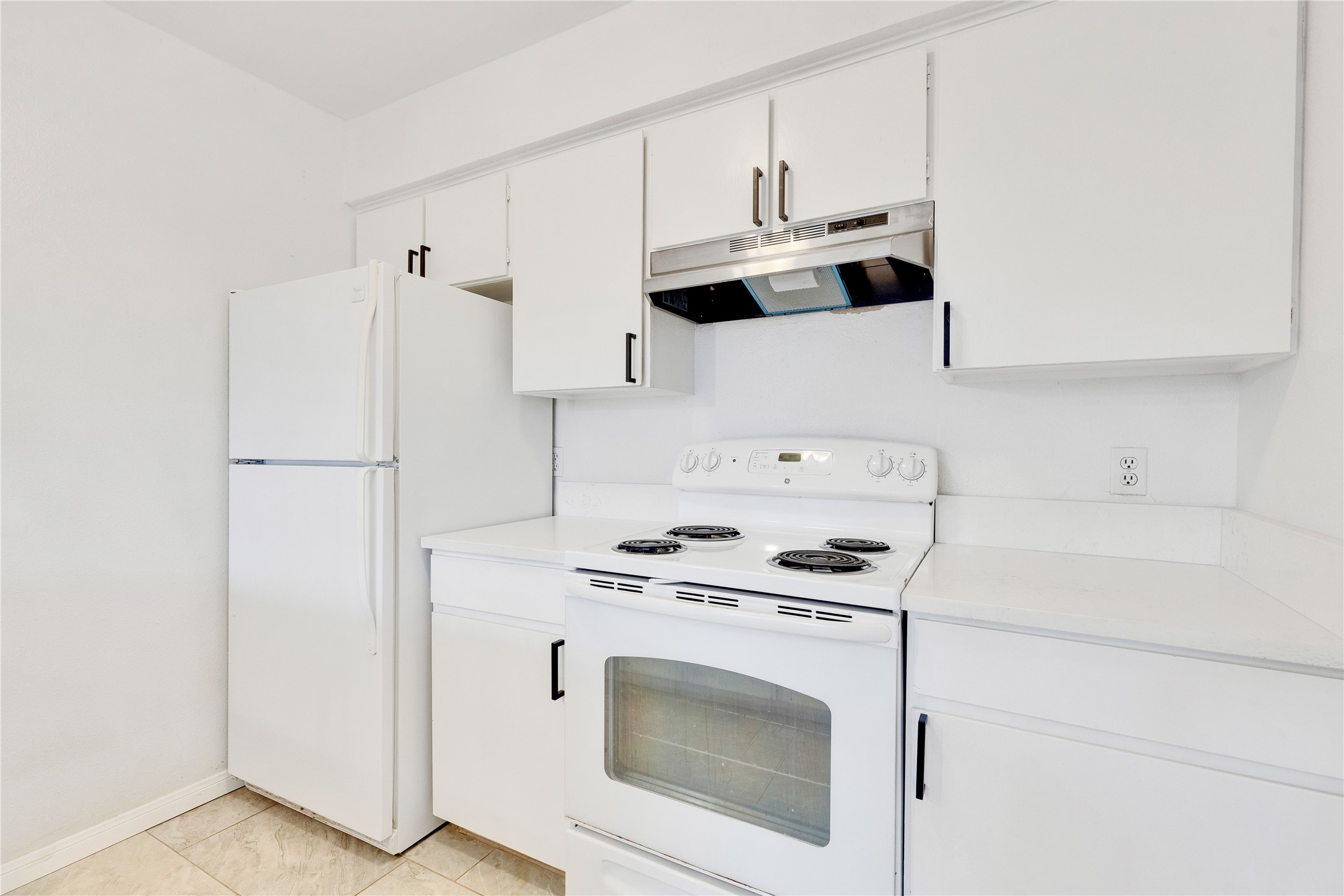 6910 Hart Lane, Unit 403 Austin, TX 78731 - Photo 8 of 20 a kitchen with cabinets and white appliances