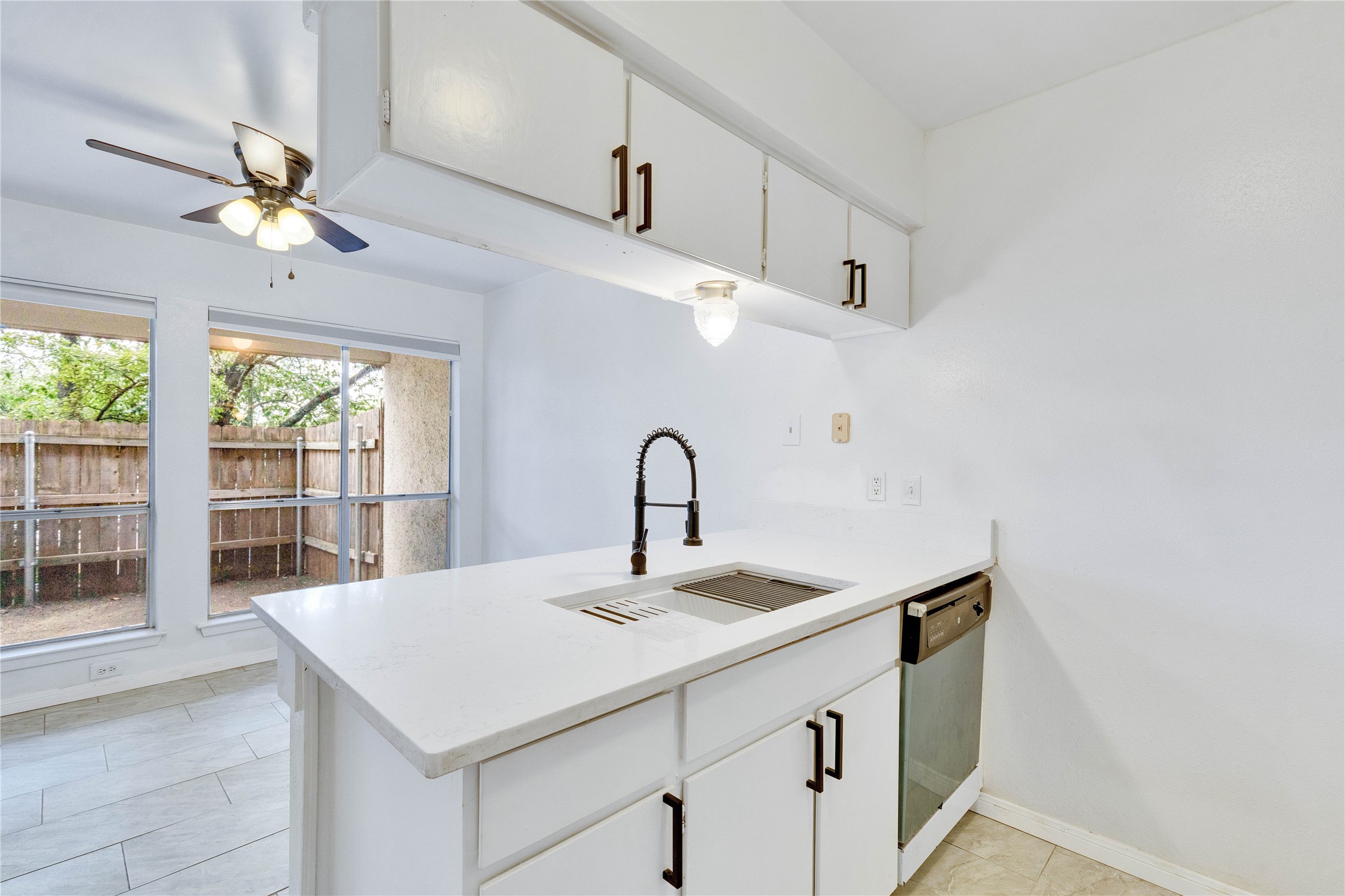 6910 Hart Lane, Unit 403 Austin, TX 78731 - Photo 9 of 20 a kitchen with a sink and a window