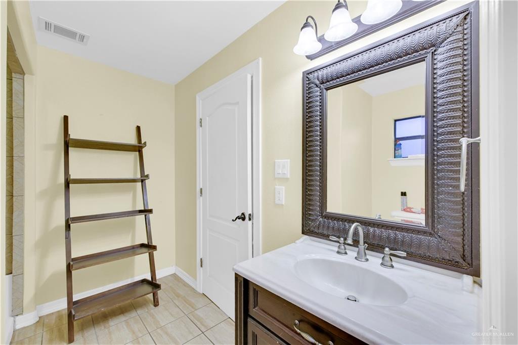 1815 Thornton Street Mission, TX 78572 - Photo 14 of 27 Bathroom featuring vanity and light tile patterned floors