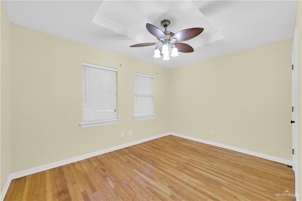 1815 Thornton Street Mission, TX 78572 - Photo 18 of 27 Empty room featuring light wood-type flooring and a ceiling fan
