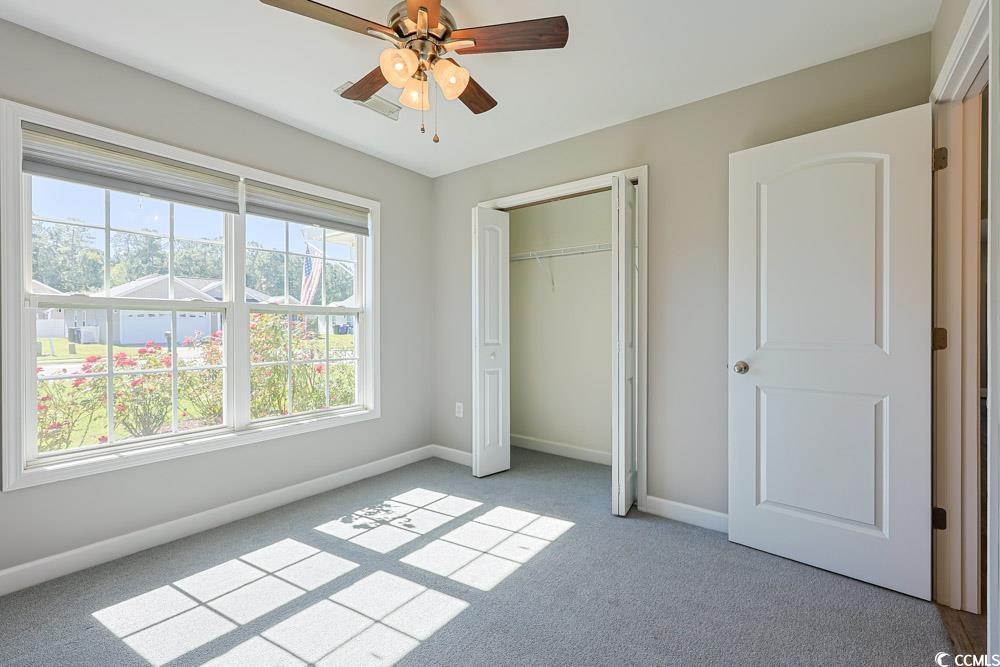 1036 Macala Drive Conway, SC 29527 - Photo 21 of 34 Unfurnished bedroom featuring carpet flooring, a ceiling fan, and a closet