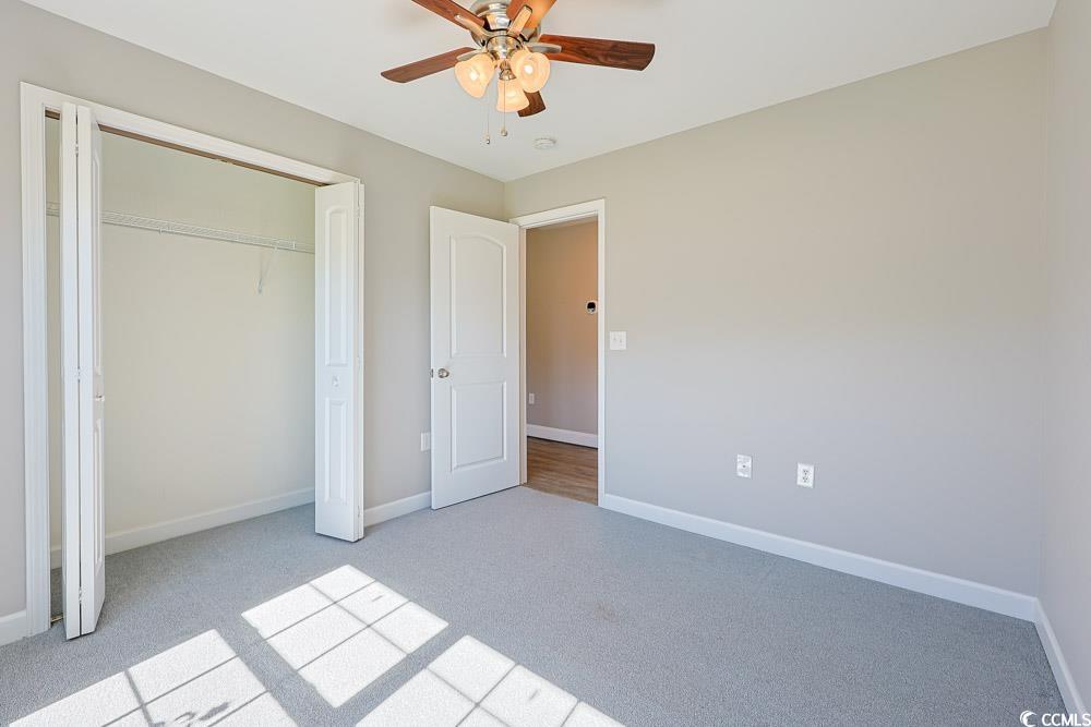 1036 Macala Drive Conway, SC 29527 - Photo 22 of 34 Unfurnished bedroom featuring light colored carpet, ceiling fan, and a closet