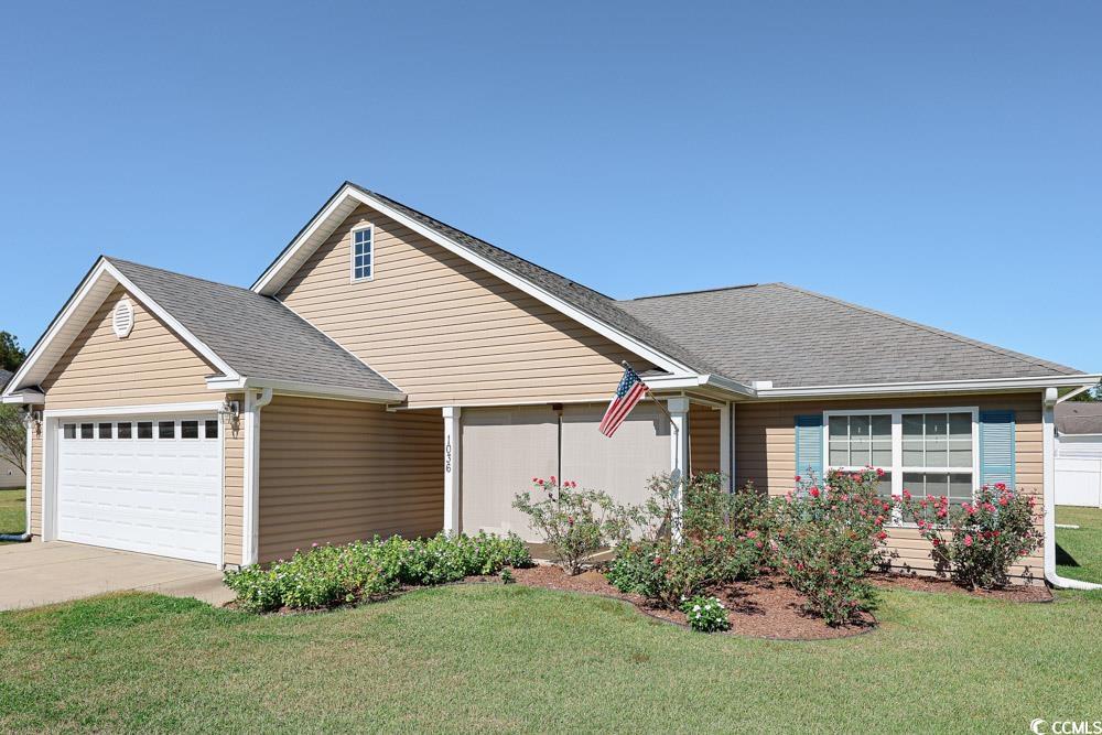 1036 Macala Drive Conway, SC 29527 - Photo 34 of 34 View of front of house with a front yard, an attached garage, roof with shingles, and concrete driveway