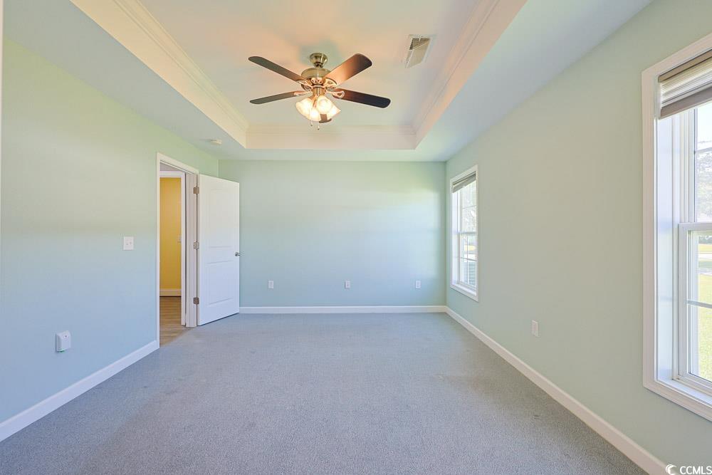 1036 Macala Drive Conway, SC 29527 - Photo 10 of 34 Empty room with ornamental molding, carpet flooring, a tray ceiling, and a ceiling fan