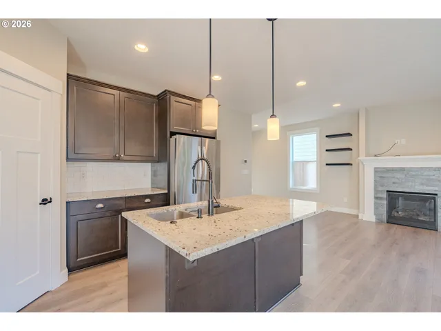 a kitchen with kitchen island a sink stainless steel appliances and cabinets