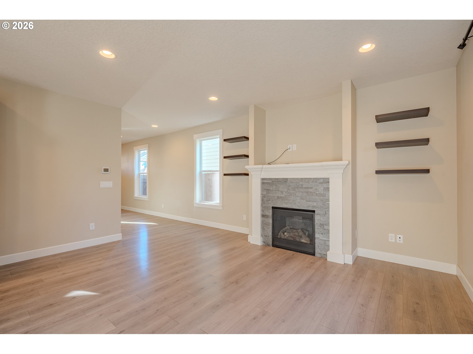 1145 South Quail Run Place Ridgefield, WA 98642 - Photo 15 of 41 a view of an empty room with wooden floor fireplace and a window
