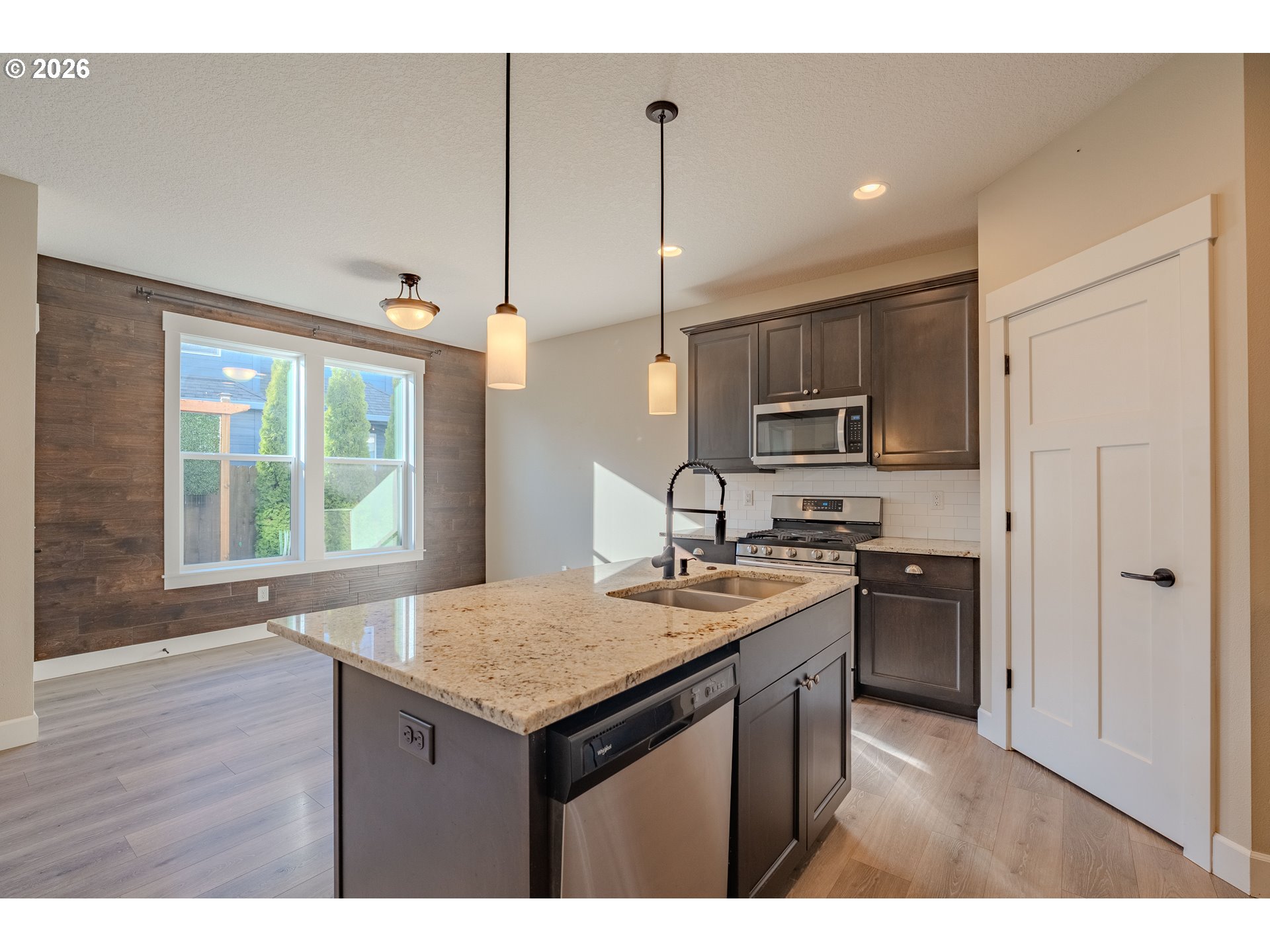 1145 South Quail Run Place Ridgefield, WA 98642 - Photo 17 of 41 a kitchen with stainless steel appliances granite countertop a sink stove and refrigerator