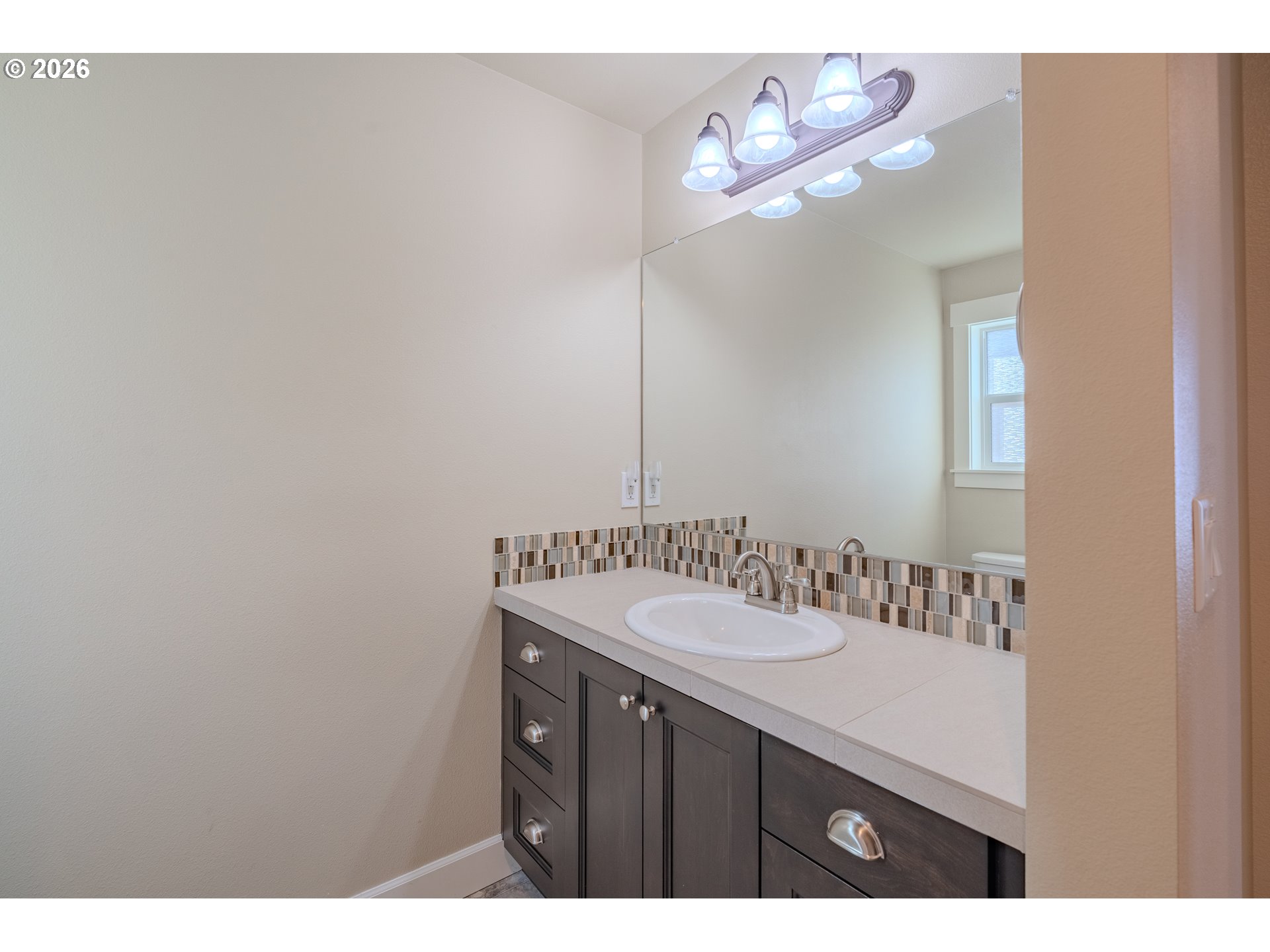 1145 South Quail Run Place Ridgefield, WA 98642 - Photo 29 of 41 a bathroom with a sink and a mirror