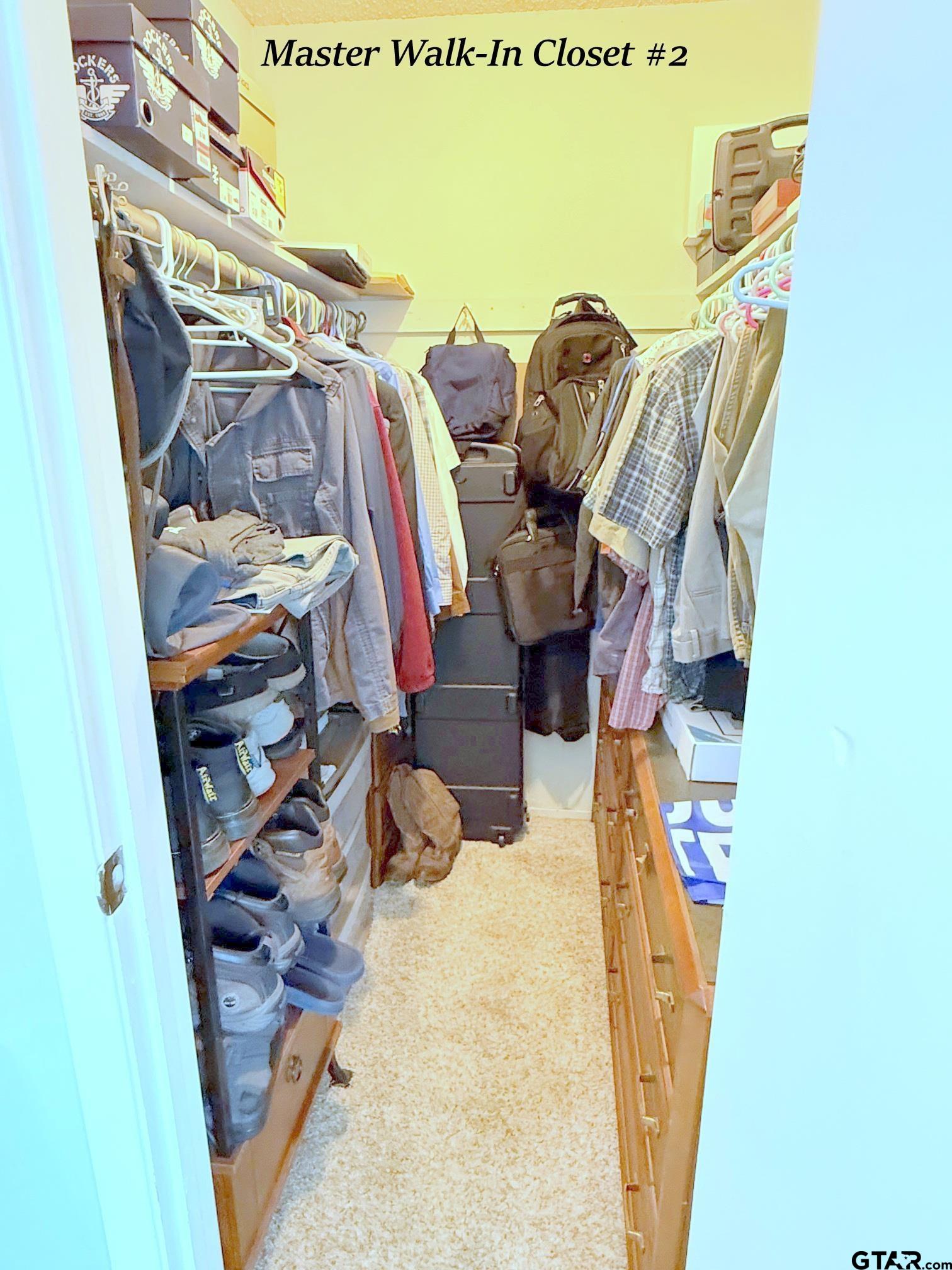 237 Oregon Street Van, TX 75790 - Photo 25 of 44 a view of walk in closet with clothes and shoes