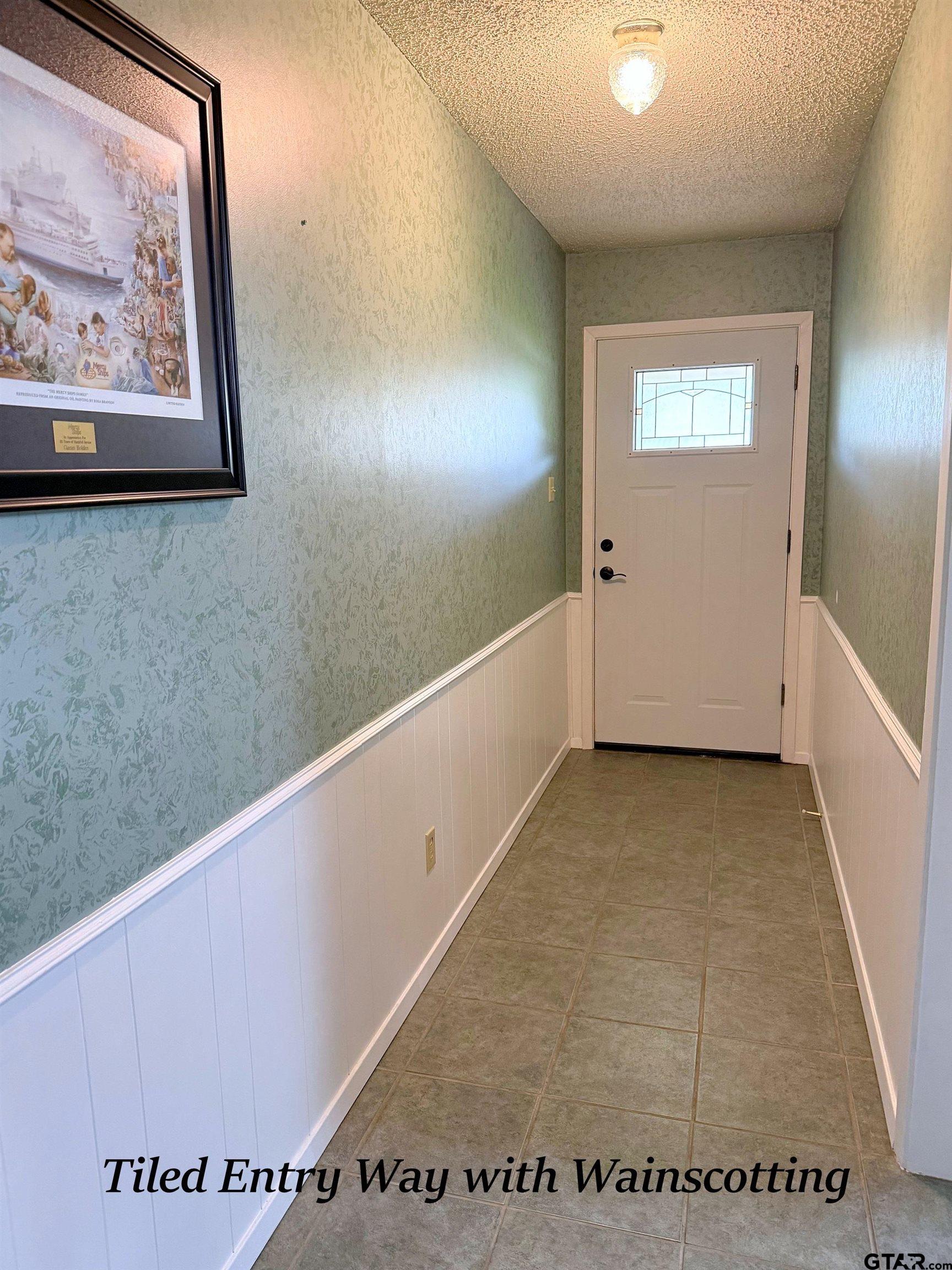 237 Oregon Street Van, TX 75790 - Photo 4 of 44 a view of a hallway with paintings on the wall