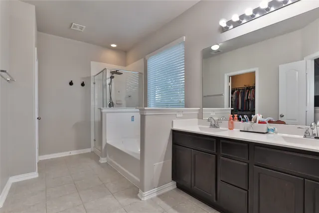a bathroom with a double vanity sink mirror and double