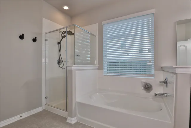a bathroom with a bathtub and a shower