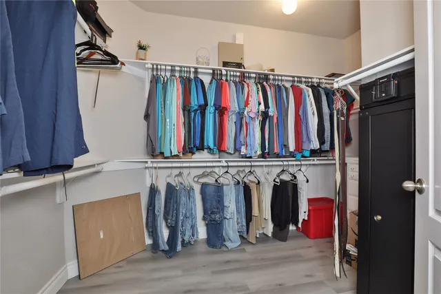 a view of walk in closet with clothes
