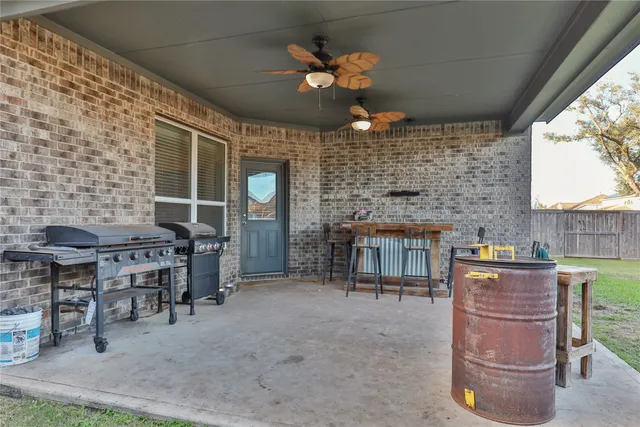a view of a porch with a table and chairs