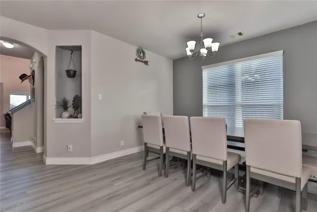 a view of a dining room with furniture and chandelier
