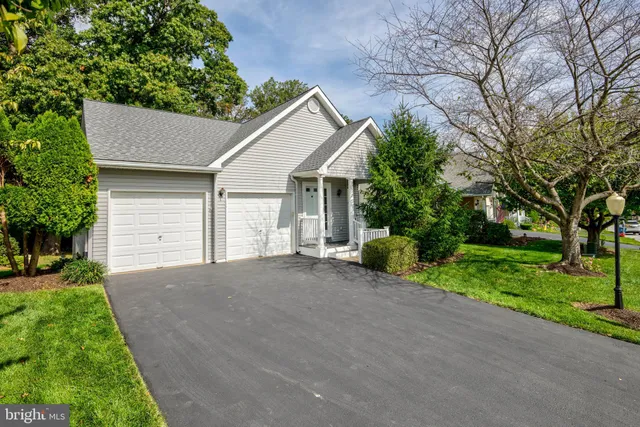 a view of a house with a yard and garage
