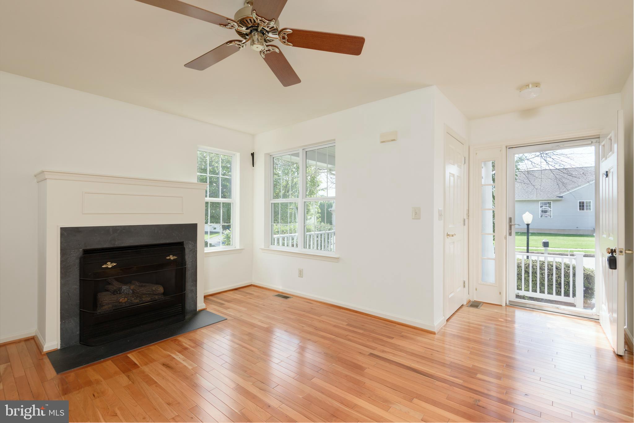 403 East Glenview Drive West Grove, PA 19390 - Photo 3 of 25 a view of an empty room with a fireplace and a window