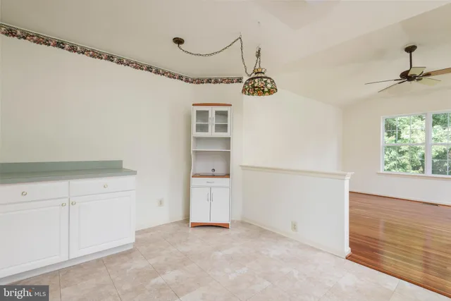 a view of a refrigerator in kitchen and cabinets