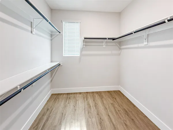a view of a room with wooden floor and white walls