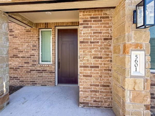 front view of a brick house with an empty space