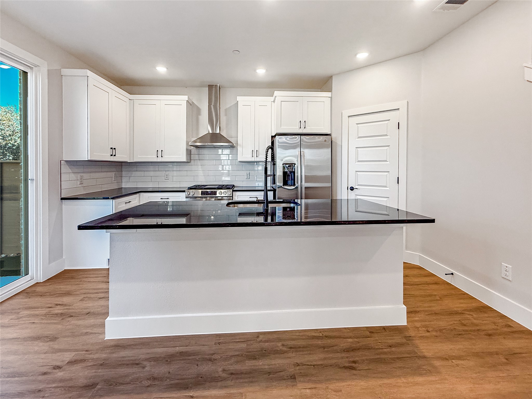 5601 Mobeetie Loop Bee Cave, TX 78738 - Photo 4 of 23 a kitchen with kitchen island a counter top space cabinets and stainless steel appliances