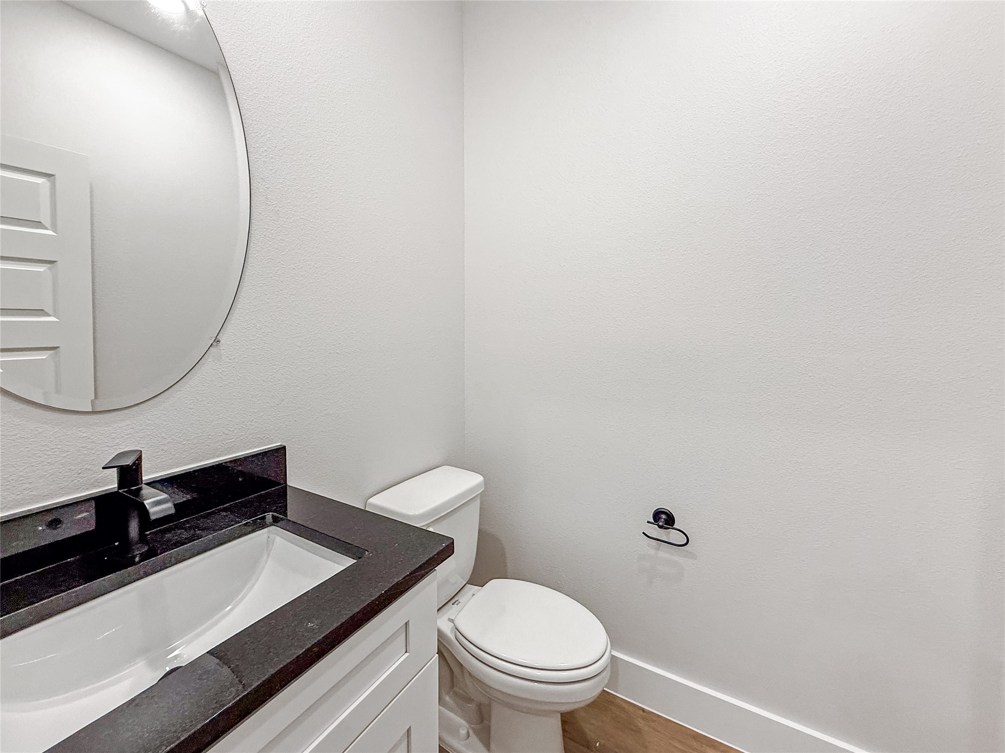5601 Mobeetie Loop Bee Cave, TX 78738 - Photo 7 of 23 a bathroom with a sink a toilet and a mirror