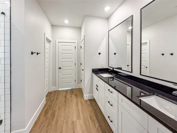 a spacious bathroom with a granite countertop sink and a mirror