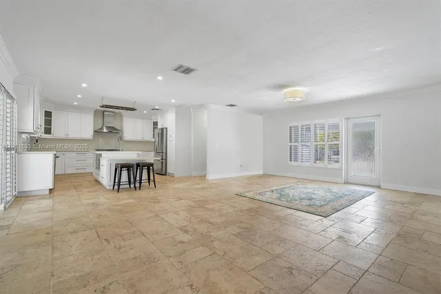 a view of kitchen with granite countertop lots of counter top space and appliances