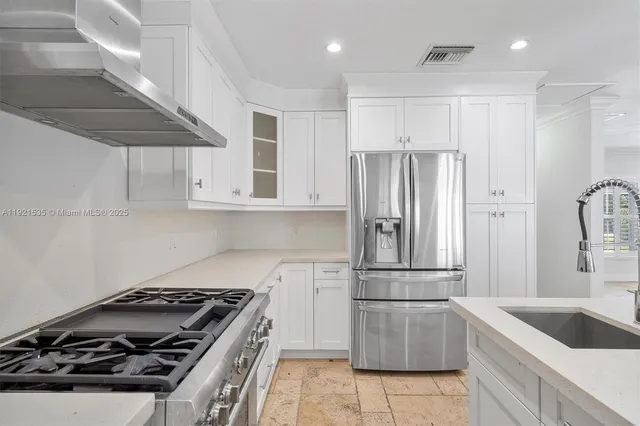 a kitchen with a refrigerator and a sink